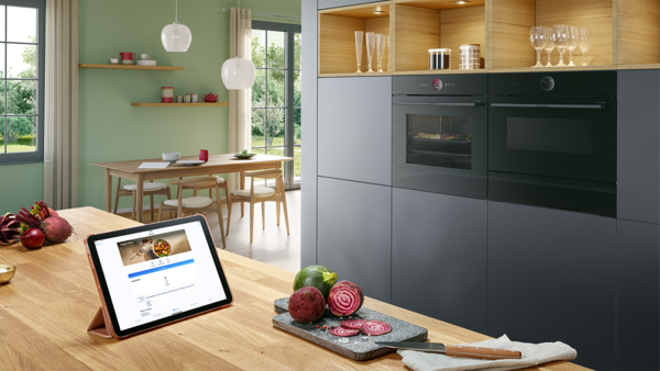 Bosch oven and a tablet showing a recipe in the Home Connect app
